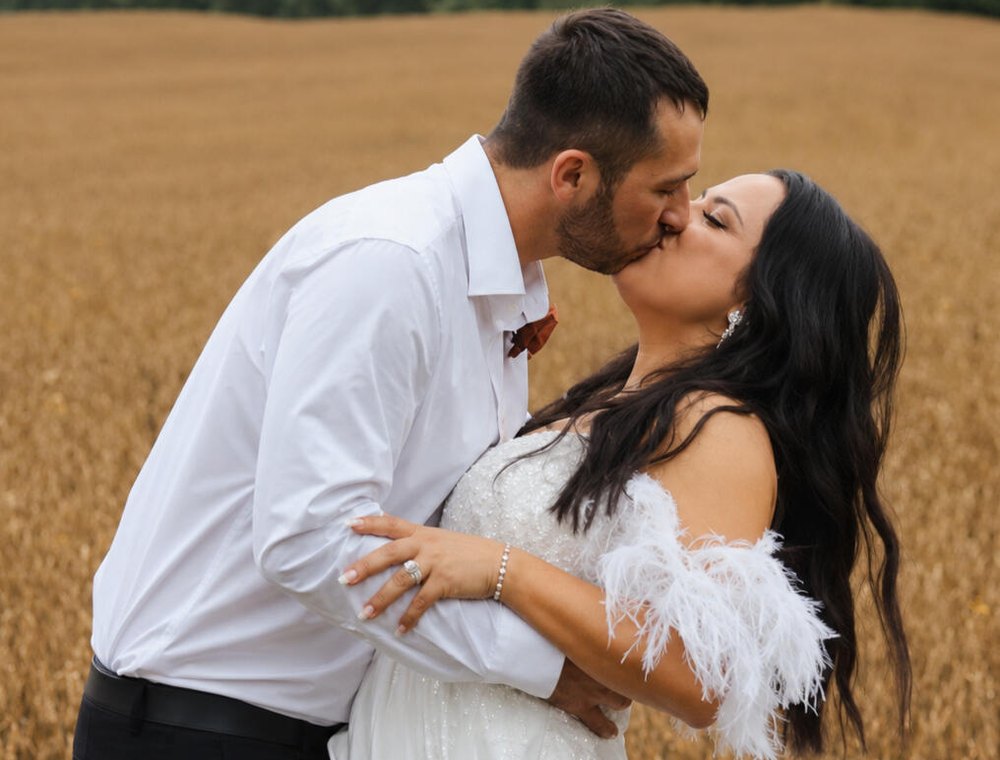 Bride and groom kissing in a wheat field, shot by JS Media